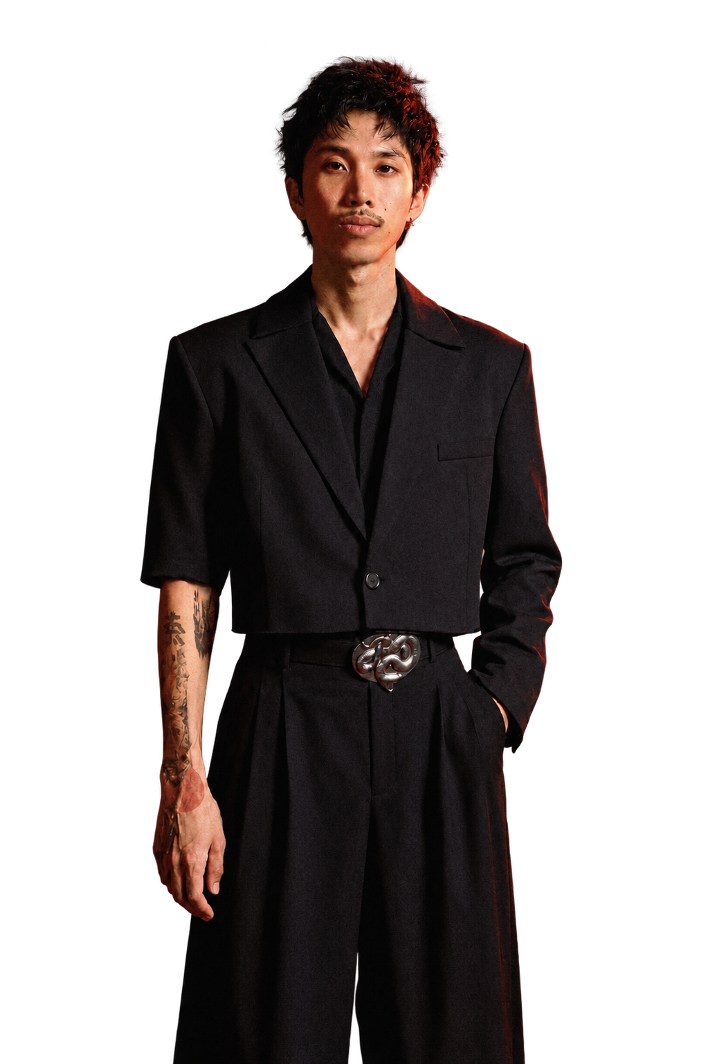 Nacholas Newman standing in a black suit